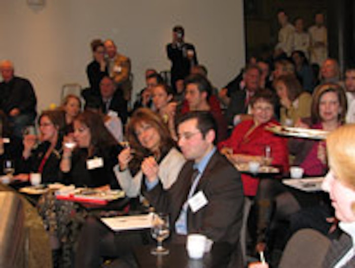 Attendees sampling chocolate-citrus lollipops prepared by chef Zac Young at NAFFS winter meeting.