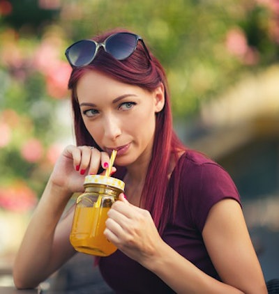 A young person drinking juice