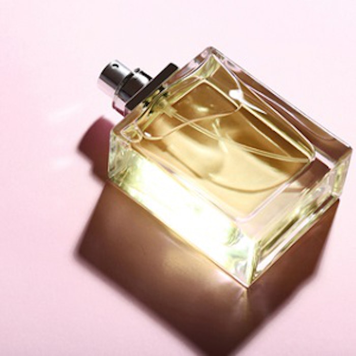 Perfume bottle on pink background