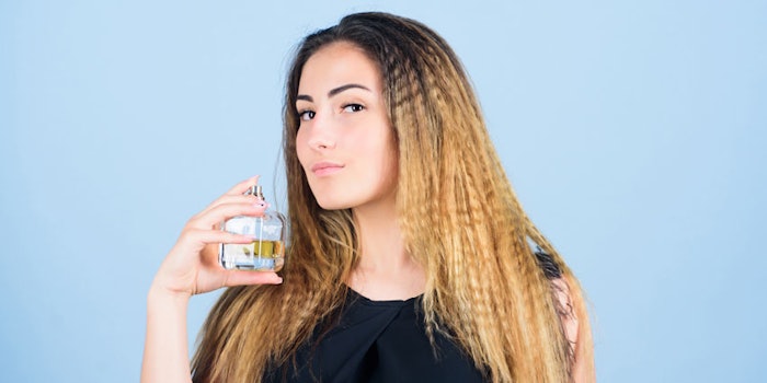 WomanSprayingFragrancecrimpyhair850x425