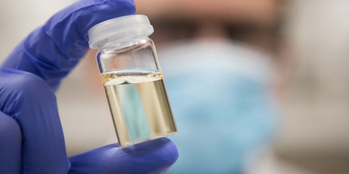 ChemistLabGlovedBottleClearLiquidExtractConcept_850x425