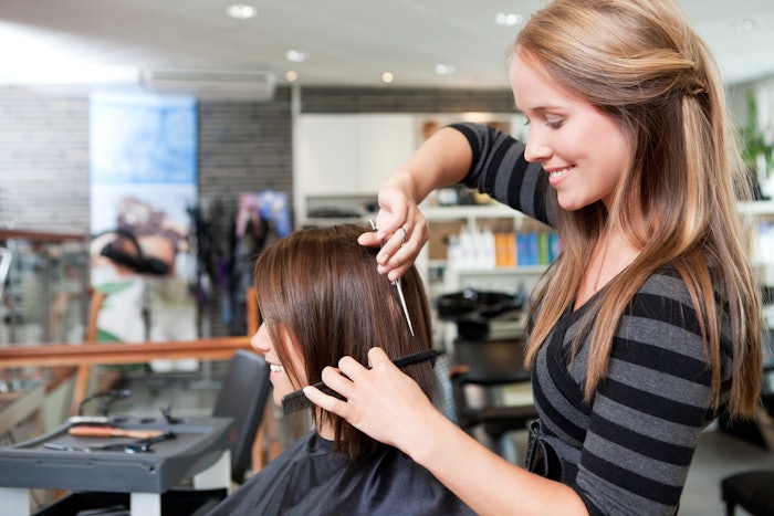 Hairstylist cutting a client's hair