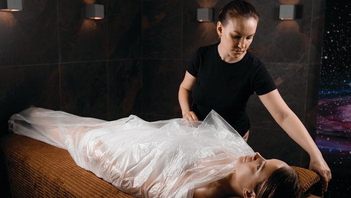 woman receiving body wrap treatment