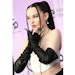 Hairstylist Clayton Hawkins created a sleek ponytail look with braided embellishments to complete Dove Cameron's AMAs look.