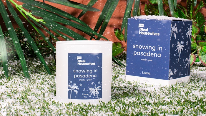 The Snowing in Pasadena candle offers scent notes of smoke and pine.