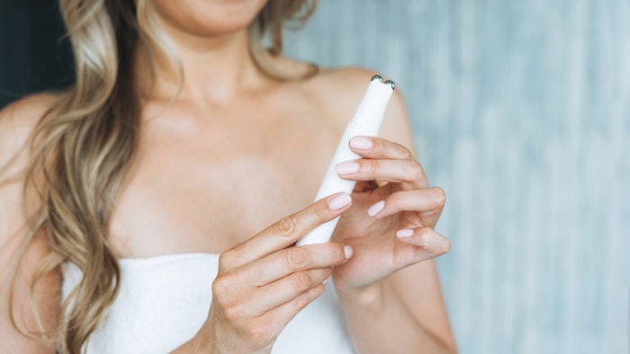 Woman using at-hom skin care device.