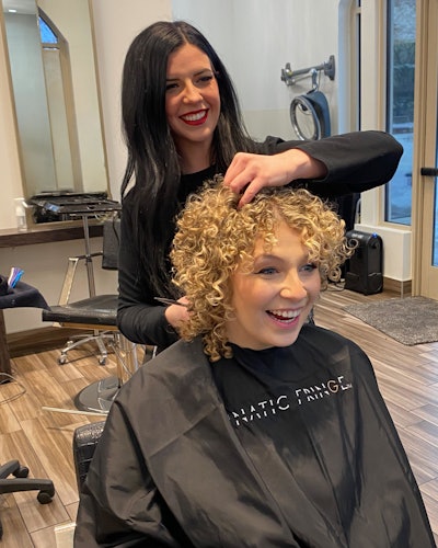 Ellen Devine styles her client's hair.