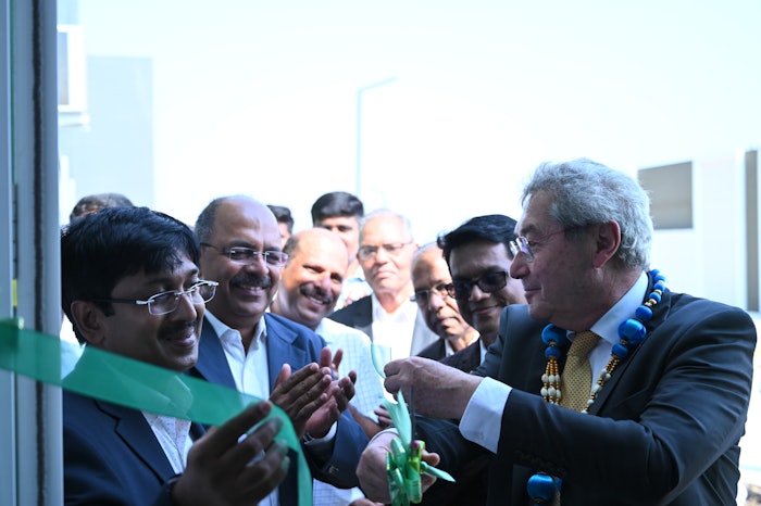 Mane president Jean Mane cutting the ribbon to celebrate the debut of the facility.