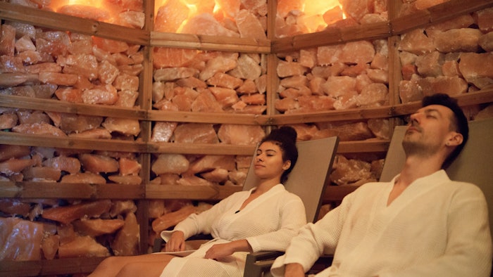Portrait of young couple in salt inhalation steam room, relaxing.