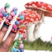 Nail artist Asia Bloodworth shares how to create colorful mushroom nail art using 2D and 3D nail gel.