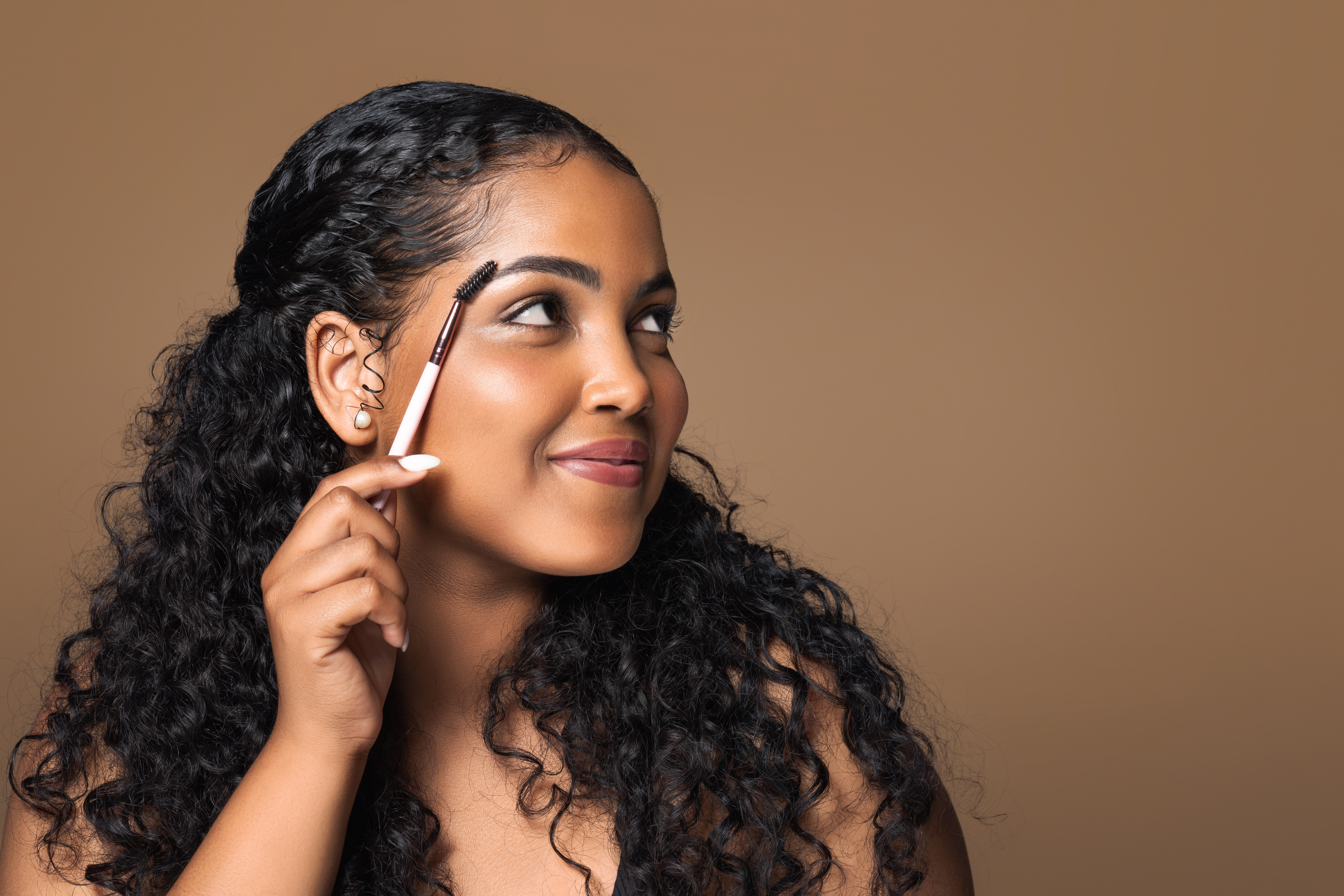 Woman brushing her eyebrows