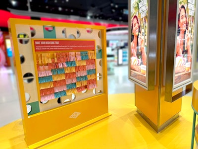 The Wishing Wall display invites customers to make a wish and receive a complimentary recycled cotton braided bracelet.