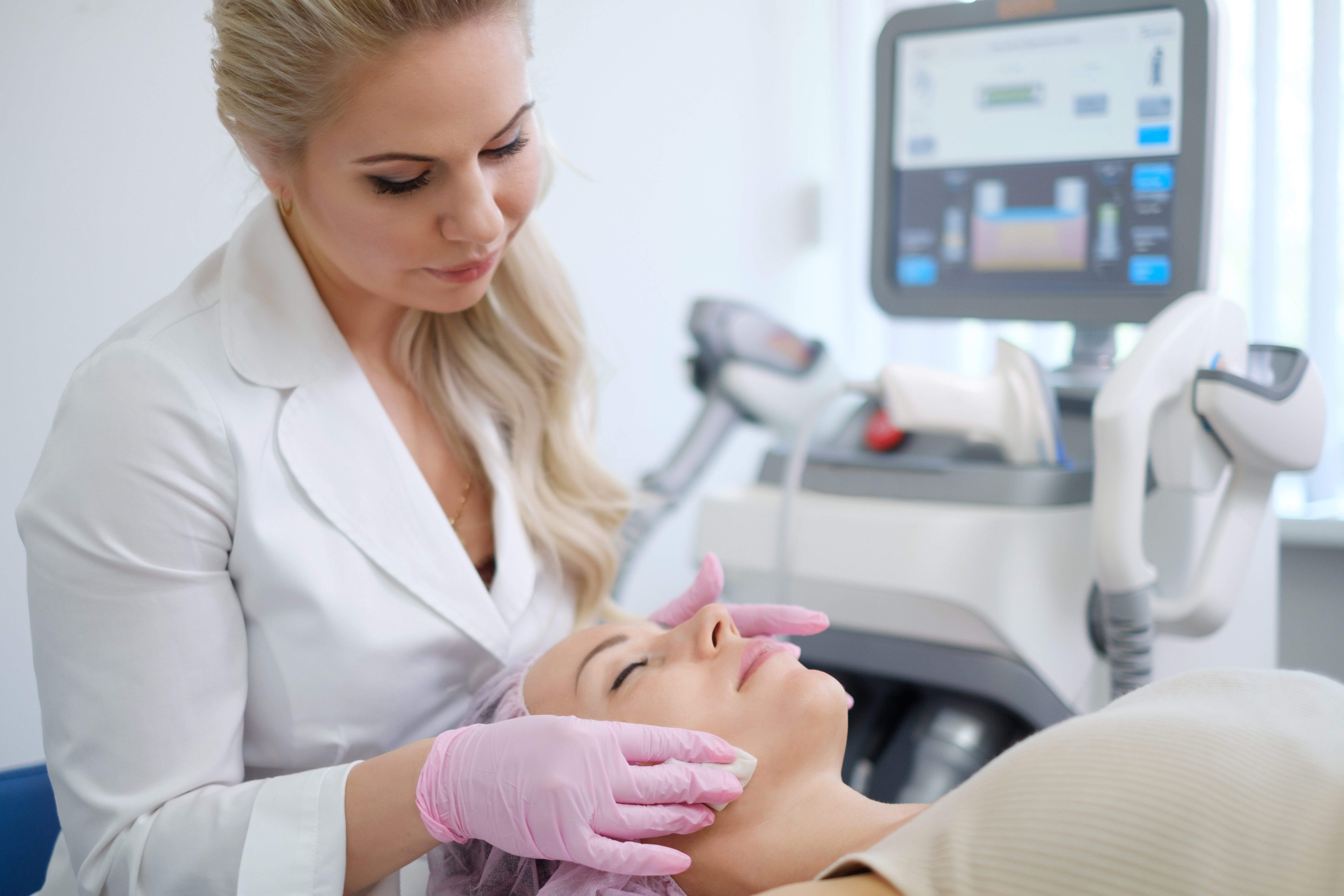 Woman getting treatment with aesthetic dermatology device