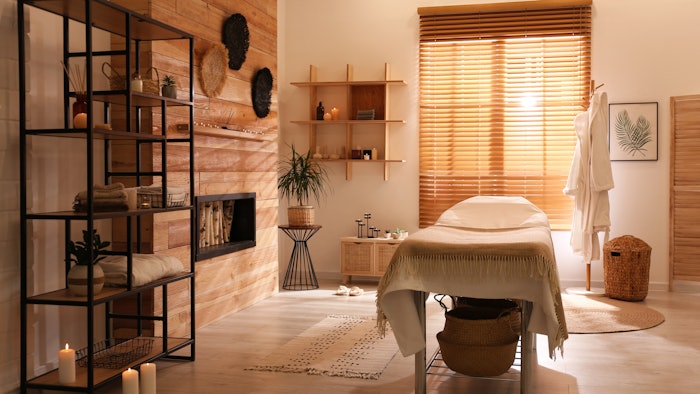 Stylish massage room interior in spa salon