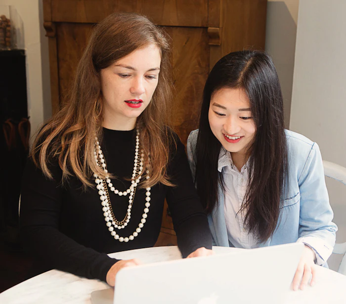 Author Ada Polla at left in 2015 with an intern. Polla writes, 'Our industry thrives on newness—we overemphasize new and underemphasize core.'