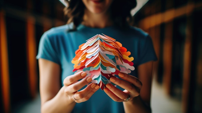 Delicate female hands cradle a vibrant brain, showcasing the diversity of human minds and the uniqueness of each individual