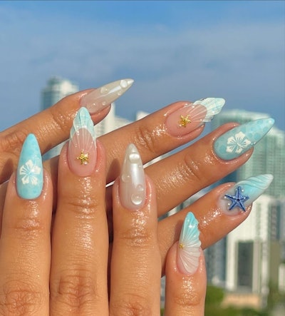 3D seashell, bubbles, and water nail art with starfish charms and floral nail designs