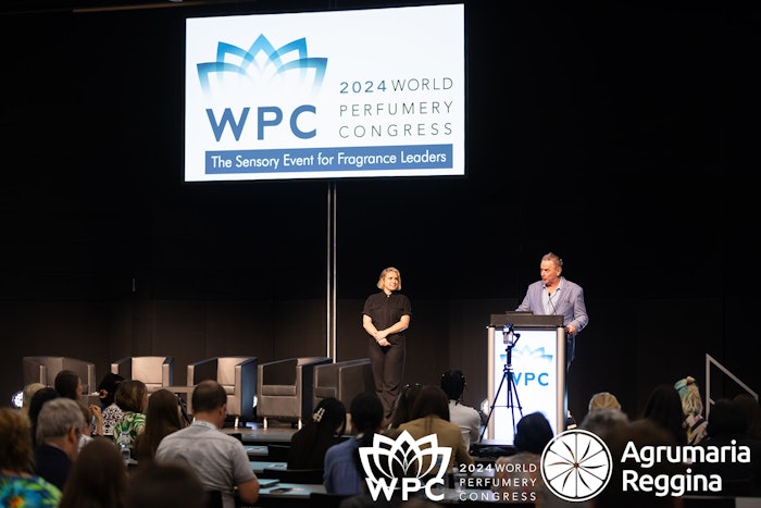 The American Society of Perfumers president James Krivda welcoming World Perfumery Congress attendees to day one of conference sessions alongside conference director Jenna Troyli (L).