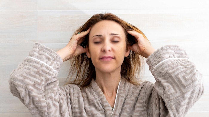 Woman Massaging Her Scalp Relaxed Happy Wearing Bath Robe Rahn Adobe Stock 558240989