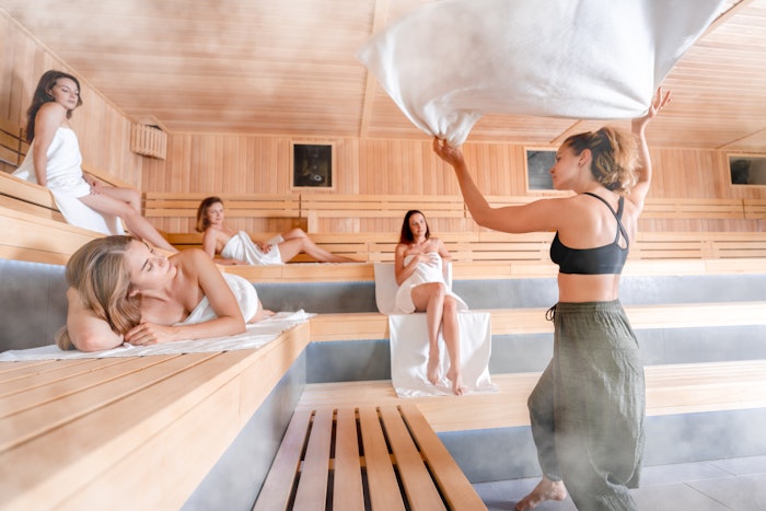 Traditional sauna ritual performed for group of females in spa center