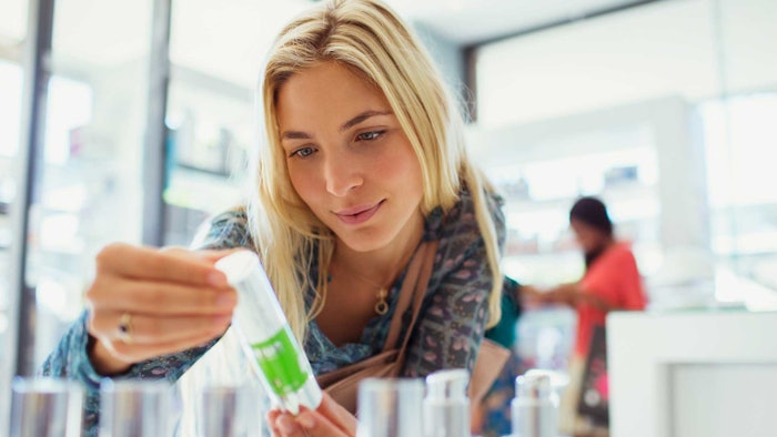 beauty consumer reading skin care product