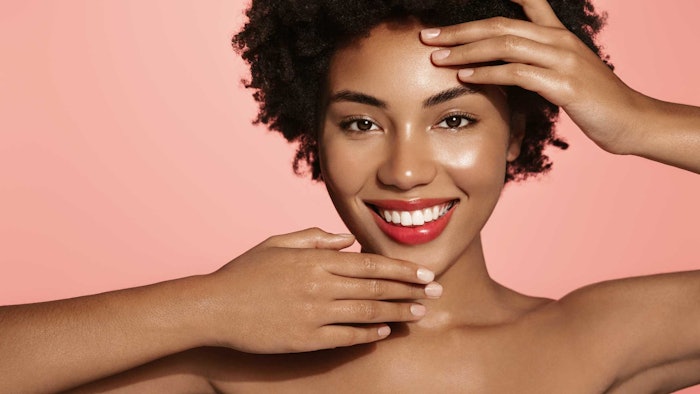 black woman young radiant skin smiling posing