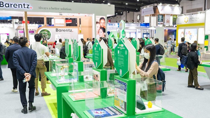 people reviewing entries in the innovation zone glass cubes on pedestals with entries inside each