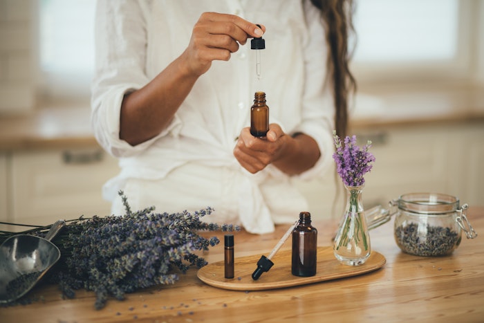 Woman performing aromatherapy with essential oils