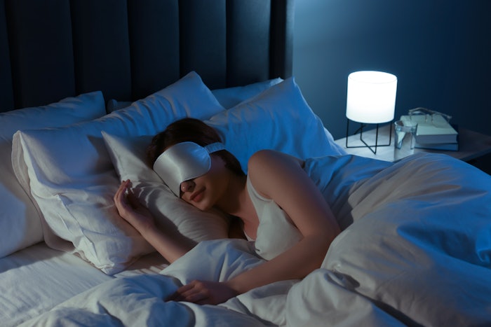 Woman sleeping in a hotel with an eye mask on