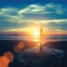 Yoga silhouette at sunset on the sea shore. Calm and self-control.