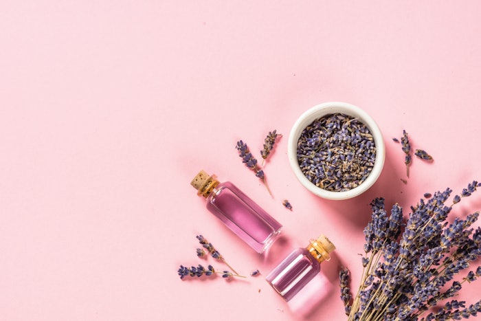 Lavender essential oil and perfume on pink