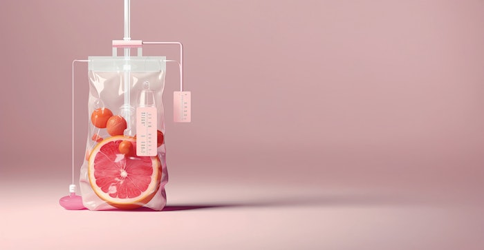 Close-up Of Various Fruit Slices In Saline Bag Dip In Water Against pink Background