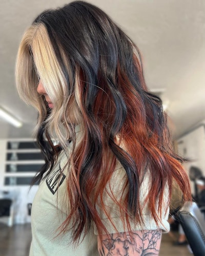 Calico hair trend with blonde money piece and brunette and copper strands