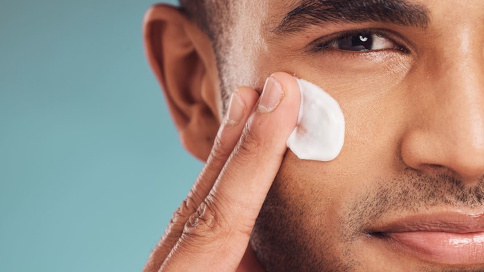 man using facial lotion