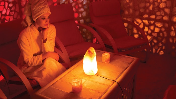 Beautiful young woman enjoying salt therapy and beauty treatment in a beauty spa