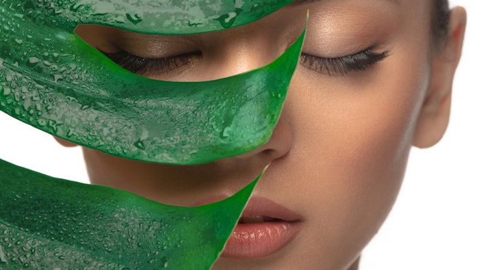 beautiful woman eyes closed wet green leaf