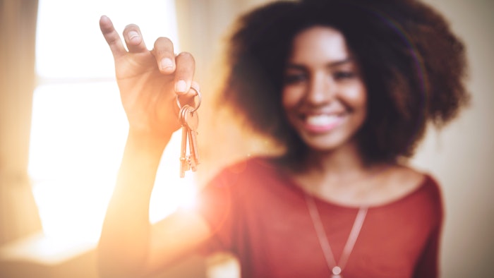 beautiful black woman holding key backlit blurred focus