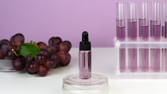 grapes extract lab glassware purple liquid and background