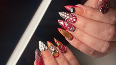 3D abstract nail art that features swirls, raised dots and a magic 8 ball