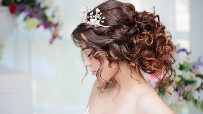 Bride wearing a crown and a wavy updo.