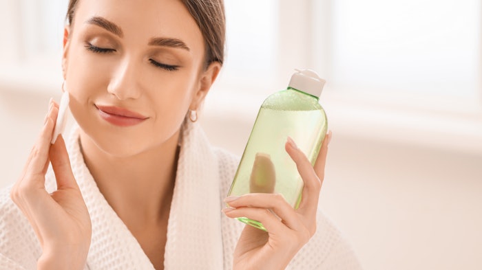 Woman Using Micellar Water Eyes Closed Relaxed Adobe Stock 920232314