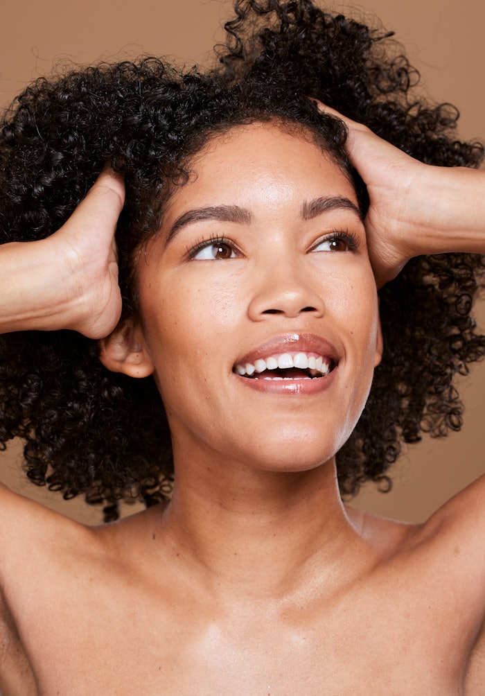 Woman With Curly Kinky Hair Smiling Hands In Hair Adobe Stock 546803711
