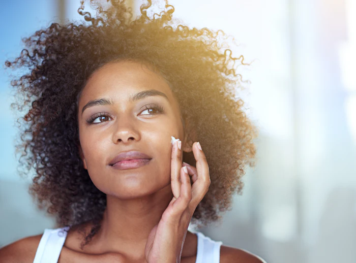 Beautiful Woman Curly Har Tan Skin Lotion On Face Adobe Stock 752212185