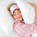 Woman In Bed In Pink Pjs Smiling Hugging Pillow Adobe Stock 1868783538 (1)