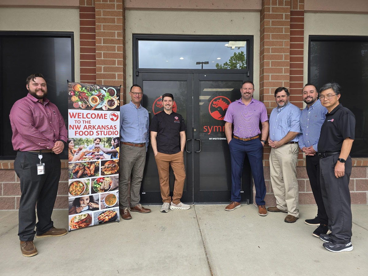 Members of Symrise's North American food and beverage team in front of the company's Northwest Arkansas Food Studio: Will Bryles - key account manager; Craig Biggers, VP of food BU; Vince Fazi, senior product development chef; Scott Haddox, senior account director; Ed Yancey, principle scientist; John Selser, key account mnanager; and Yongcheng Liu, principal scientist.