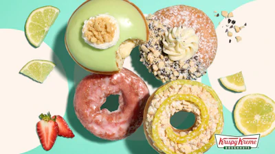 Assorted Krispy Kreme donuts with lime slices and strawberry on turquoise and cream background