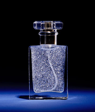 Rather than dissolving perfume oil in ethanol, Perfume Pearls encapsulate pure fragrance oil inside translucent alginate shells derived from algae. The suspended microcapsules remain stable in a structured water-based formula until sprayed, when the capsules burst within the nozzle to release fragrance alongside water.