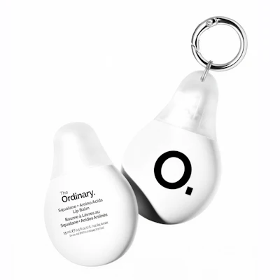 The Ordinary Squalane and Amino Acids Lip Balm keychain in white egg-shaped packaging with metal keyring