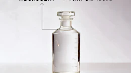 Clear glass perfume bottle labeled Aquascent with Parfum 10-25% concentration on white background