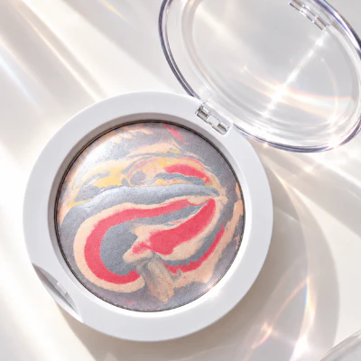 Marbled eyeshadow palette in white compact with swirled red, blue, and gold tones